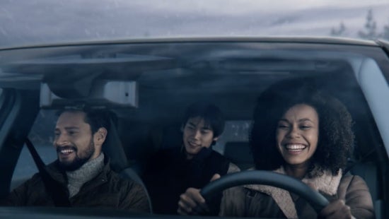 Three passengers riding in a vehicle and smiling | Mountain View Nissan of Dalton in Dalton GA